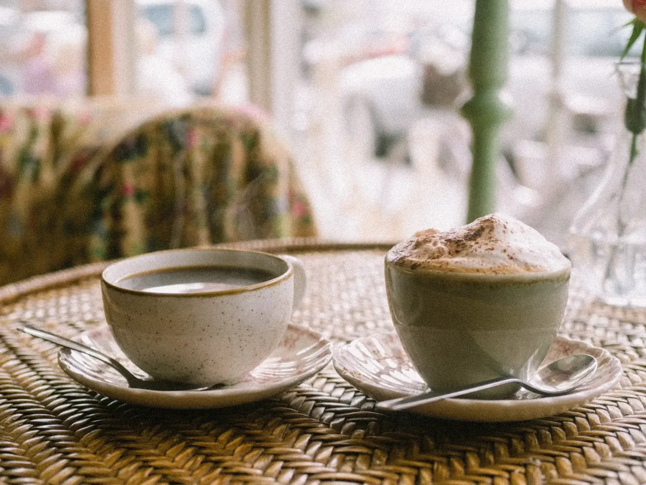 Two cups of coffee on a café table
