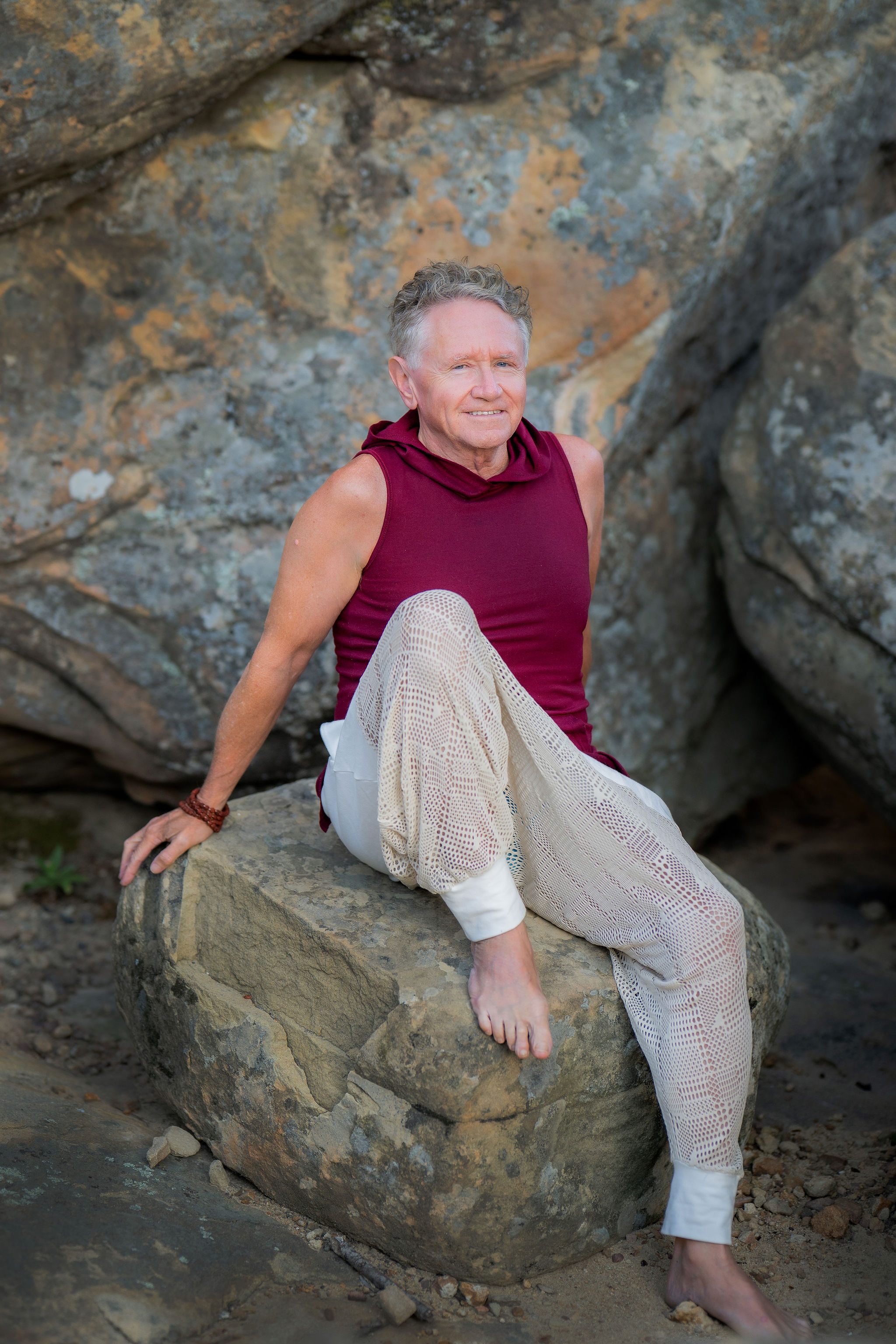 Bruce Kendall seated on sandstone rocks