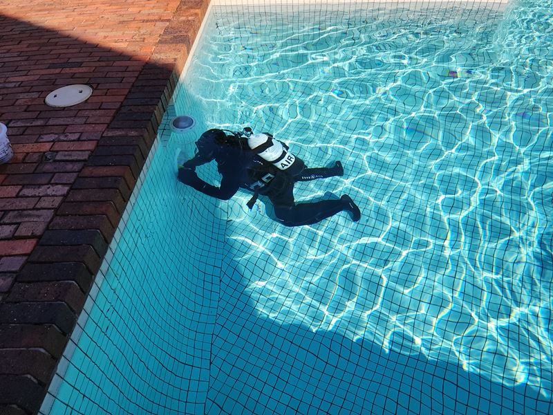 Diver checking a swimming pool shell for leaks