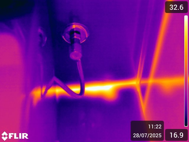 Thermal image tracing a hot water pipe inside a wall