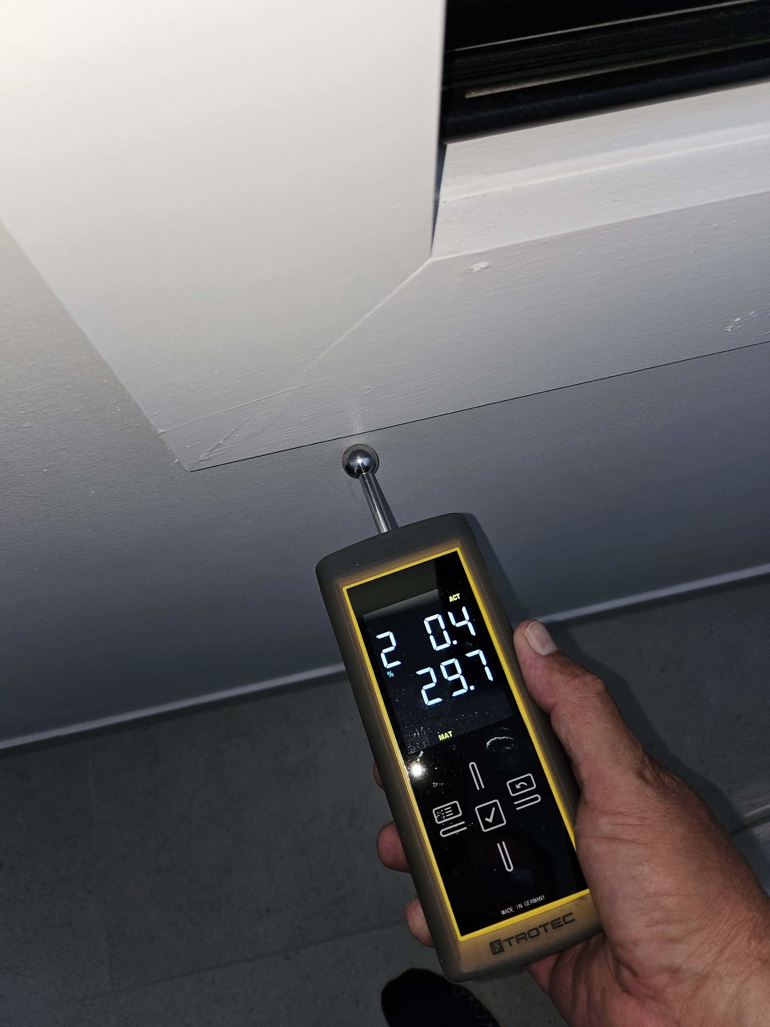 Moisture meter reading on a water-damaged ceiling