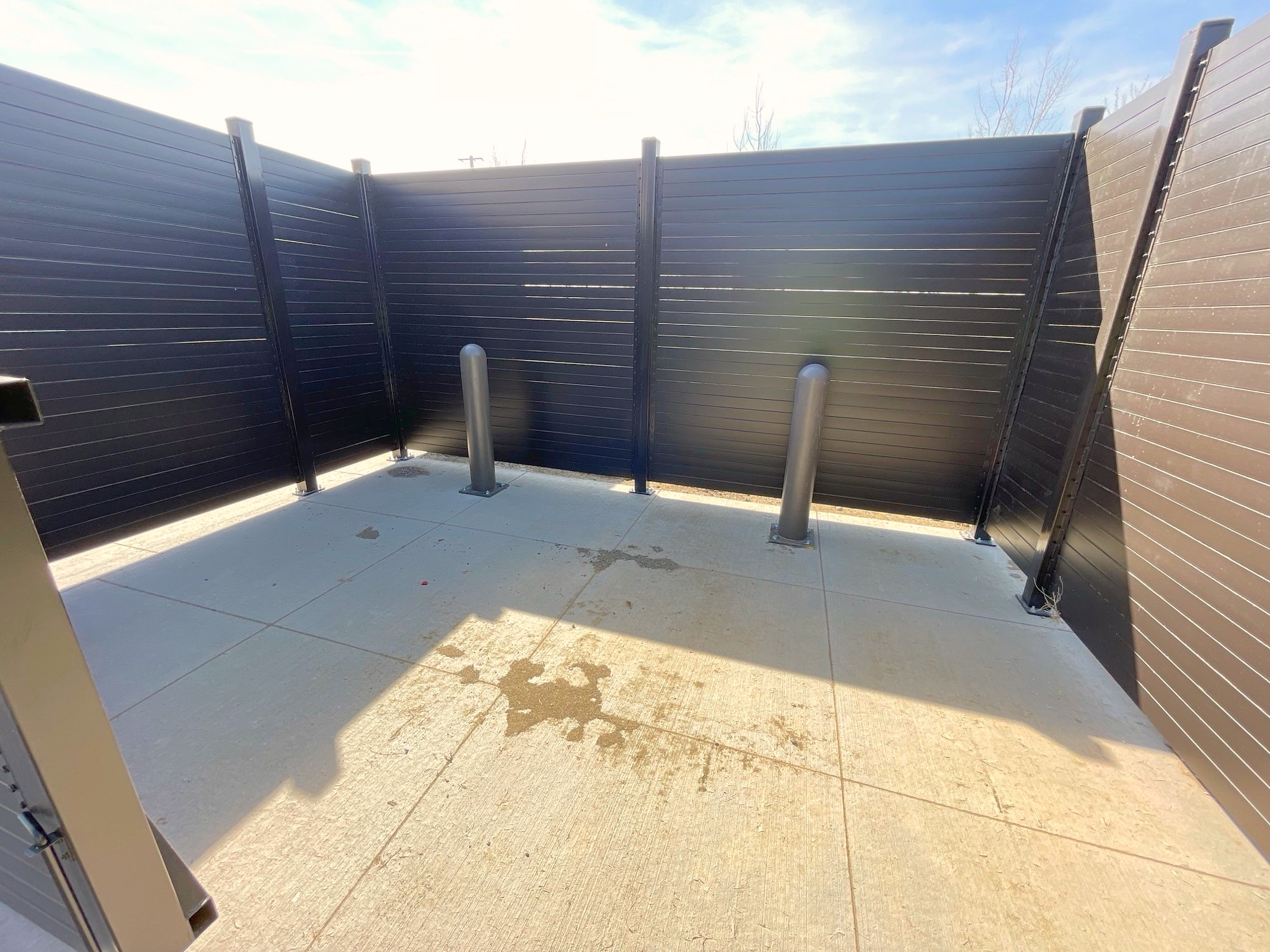 Inside a structural steel tire storage enclosure with protective bollards