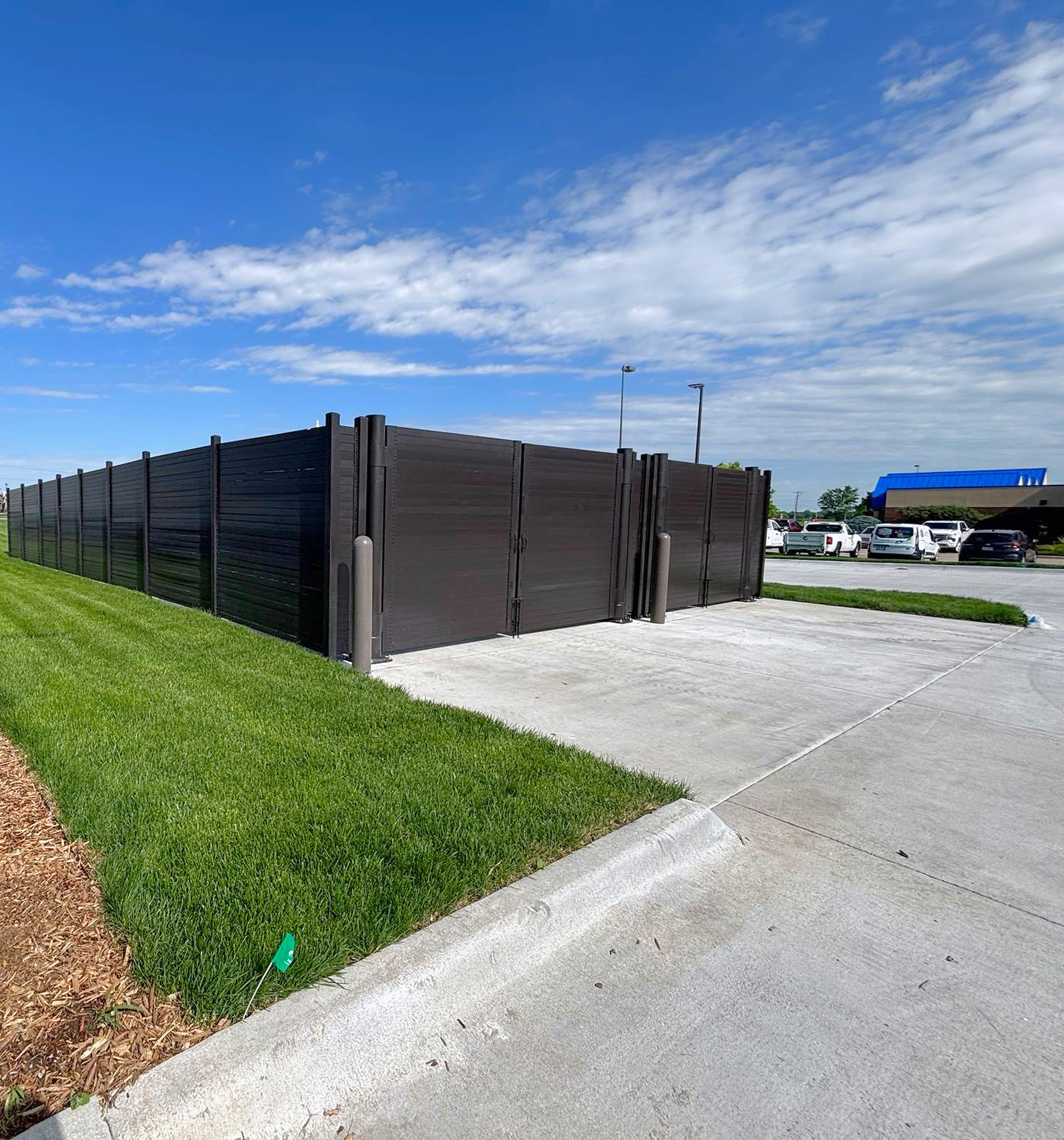 Alpine Citadel structural steel dumpster enclosure with 12 ft clear double gates
