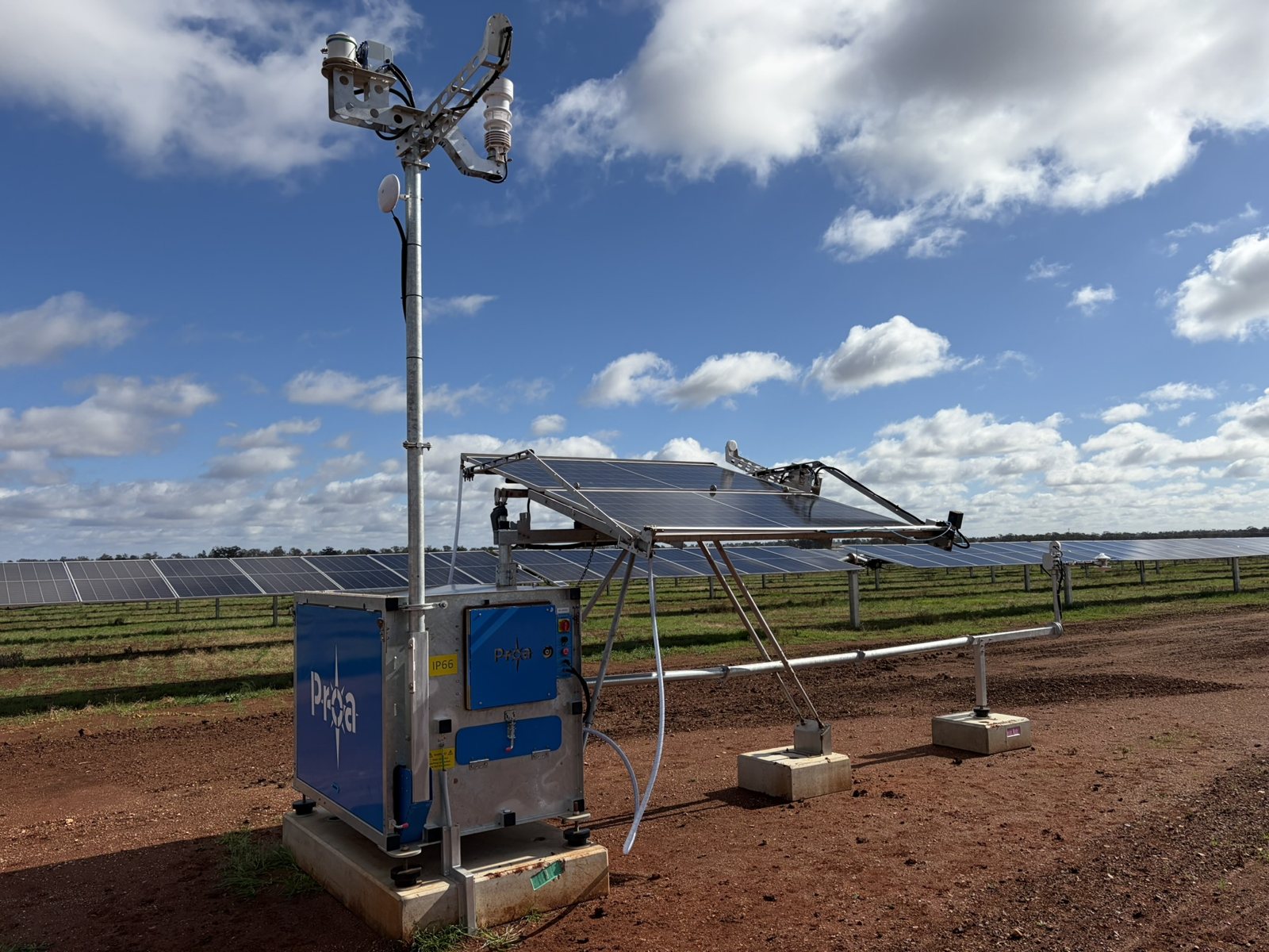 Proa MetCube enclosure with sensor mast and tilted reference modules at a solar farm