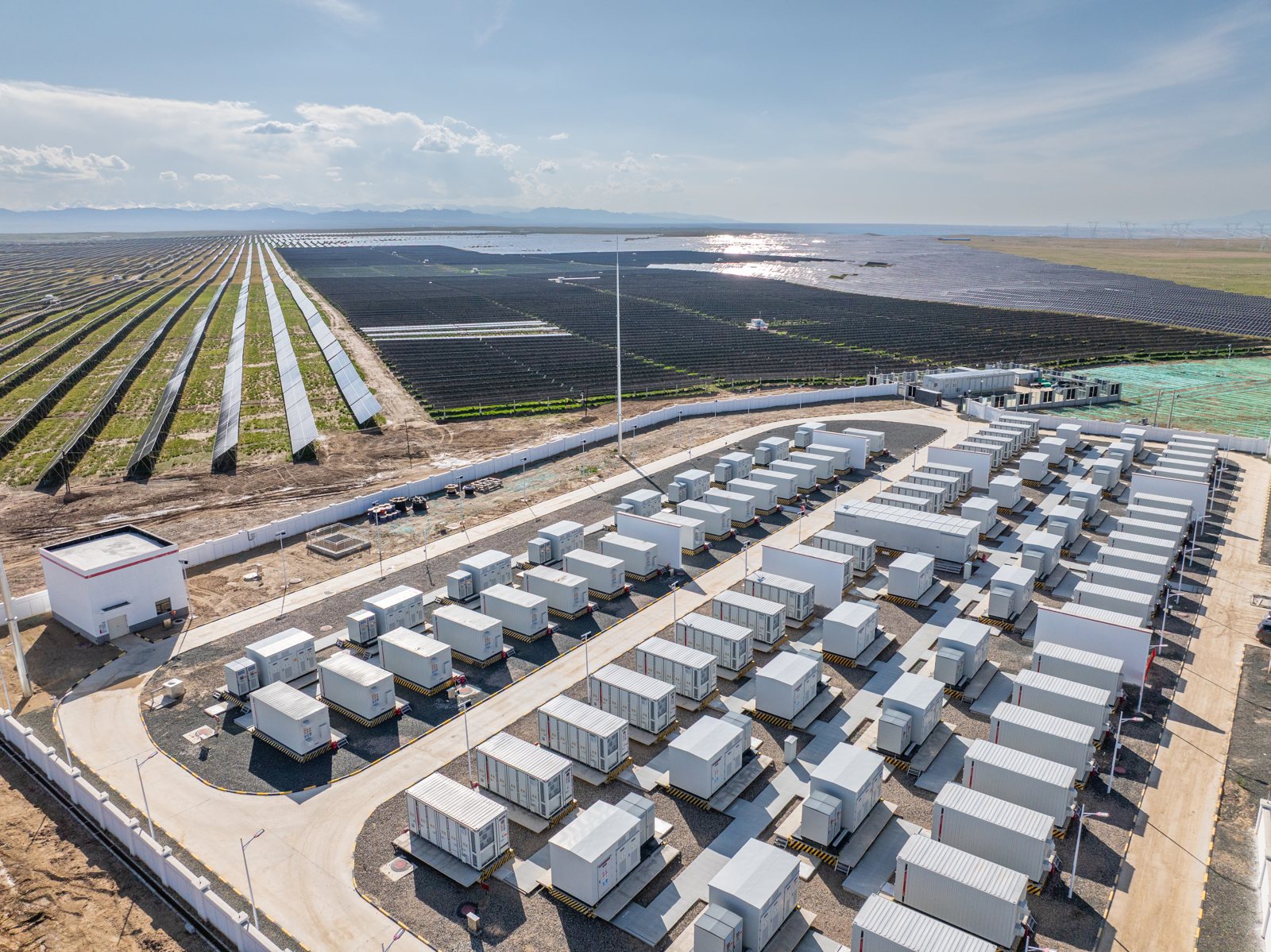 Aerial view of a battery energy storage yard beside a large solar farm