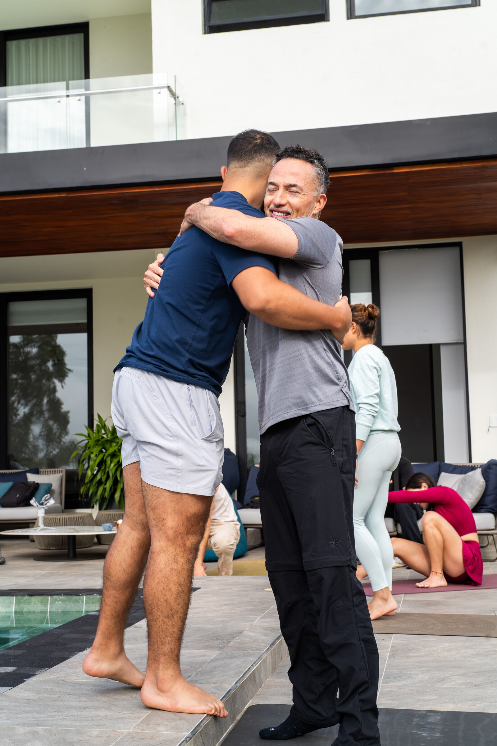 Two Founders Reset attendees embracing on the terrace.