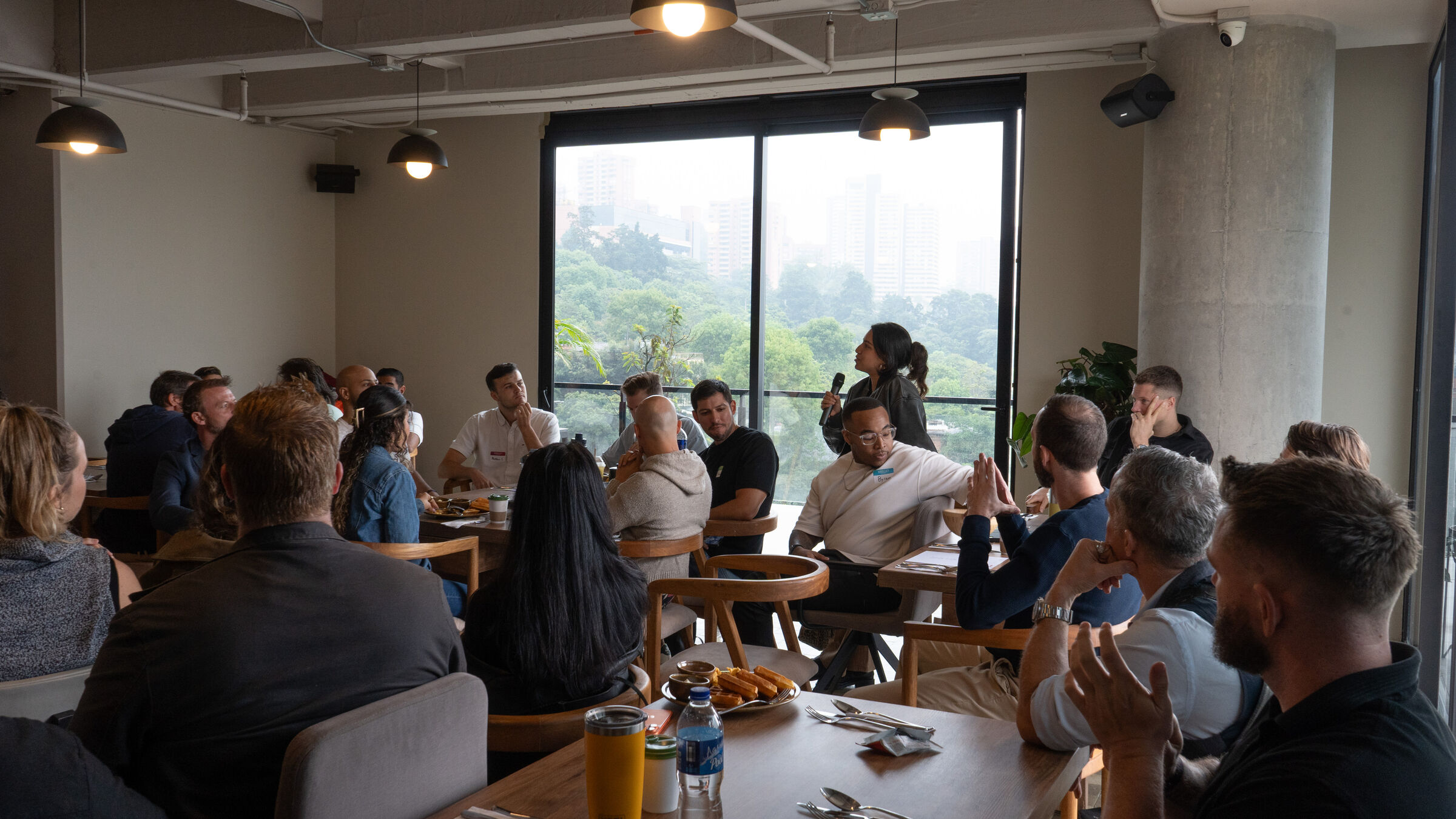 Guests seated at tables during an International Breakfast Club gathering.