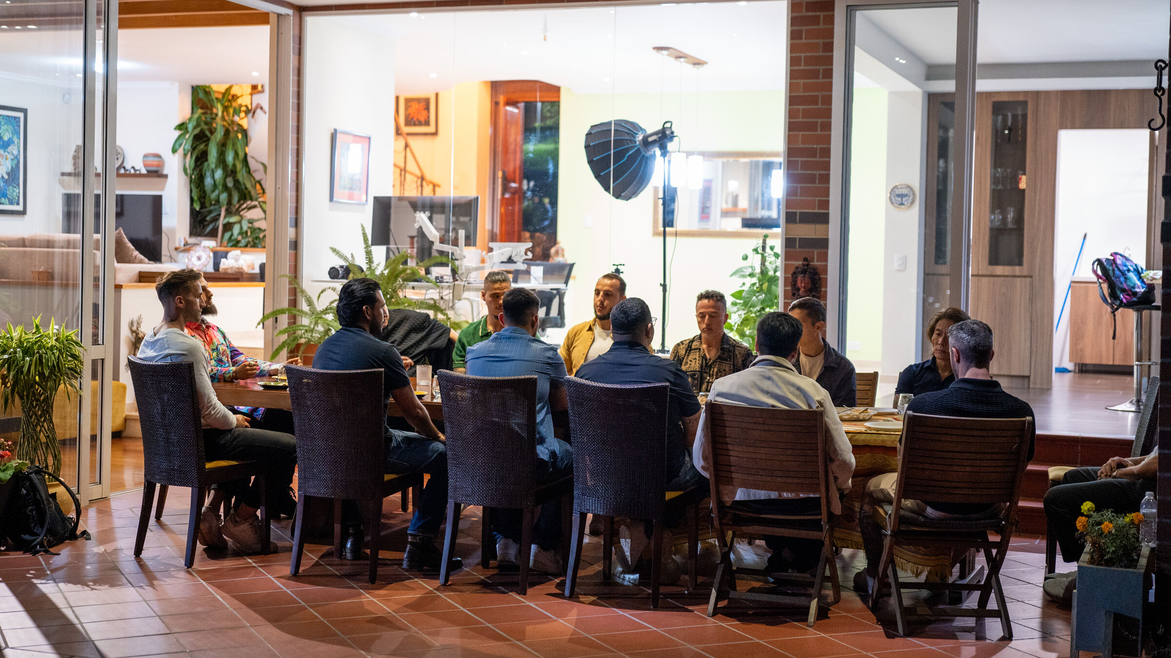 Guests seated around a long dinner table indoors at a THE ONE founders dinner.