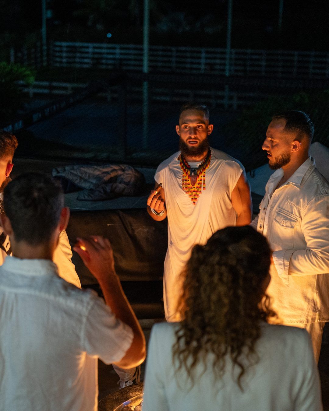 Founders Reset attendees in a close circle at night during an inner-work session.
