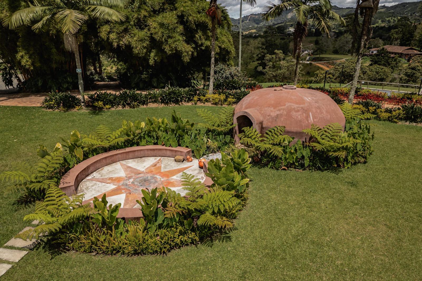 The domed temazcal beside its star-patterned ceremonial circle on the lawn at Mountains of Hope.
