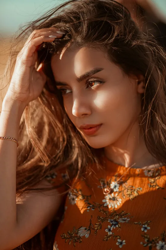 Patient in warm sunlight with her hand in her hair