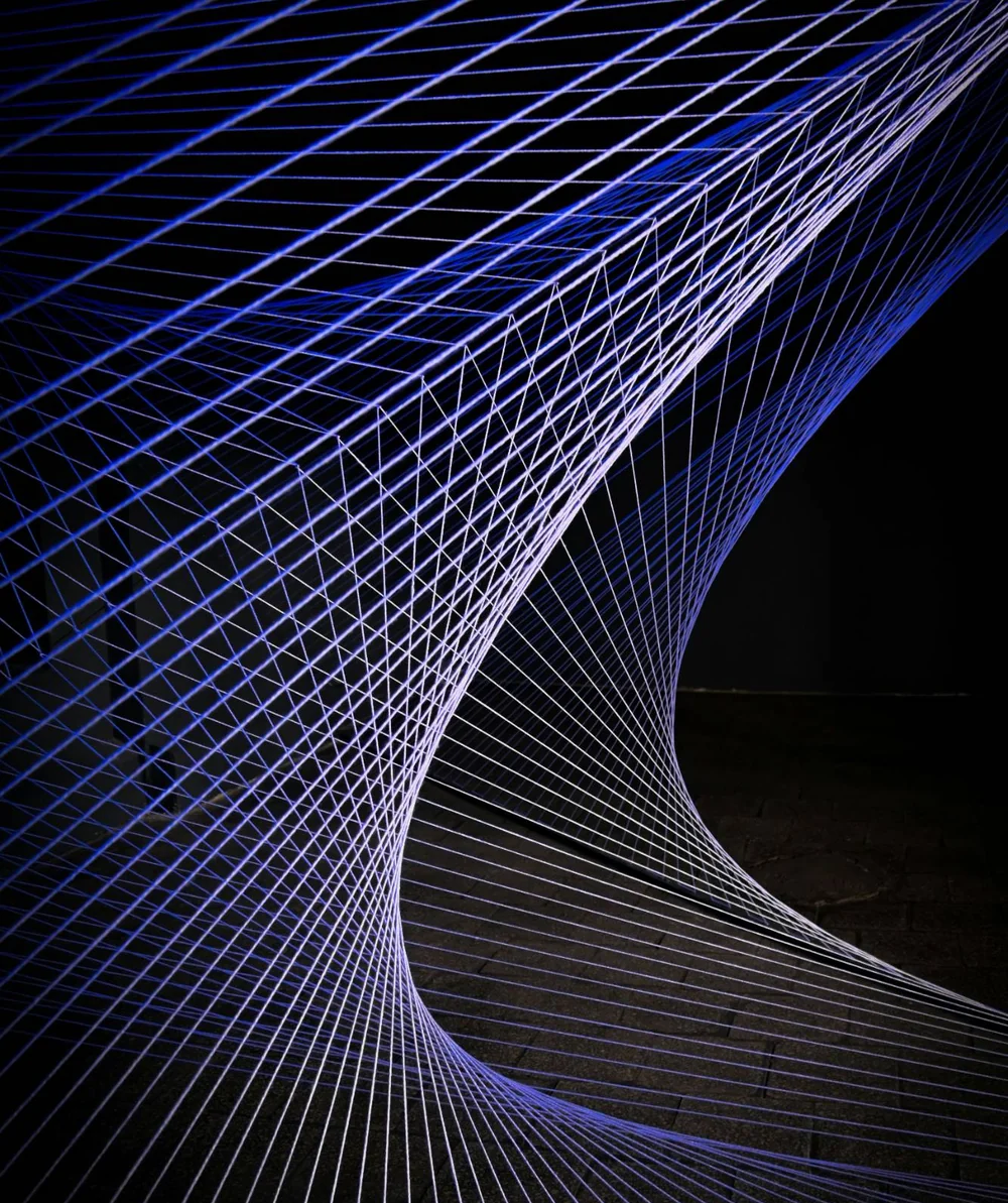 An abstract blue mesh curving into depth, representing connected enterprise systems.