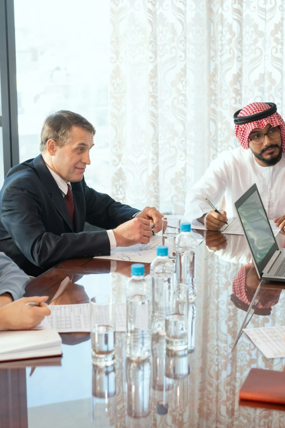 A client workshop around a boardroom table, reviewing the current estate before setting direction.