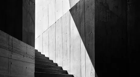 A black and white concrete stairway cut by light