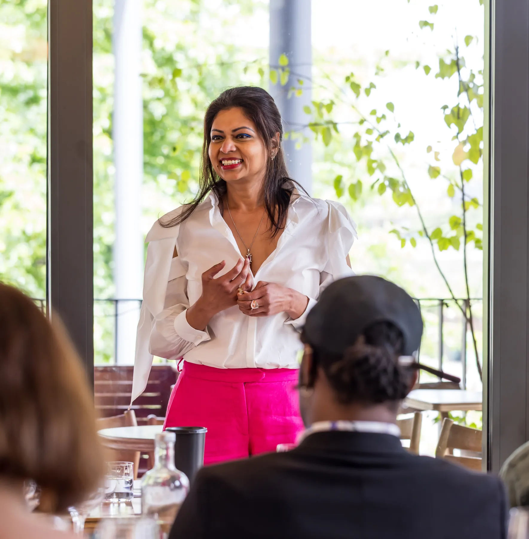 Ruchira Neotia presenting to guests seated at a long table