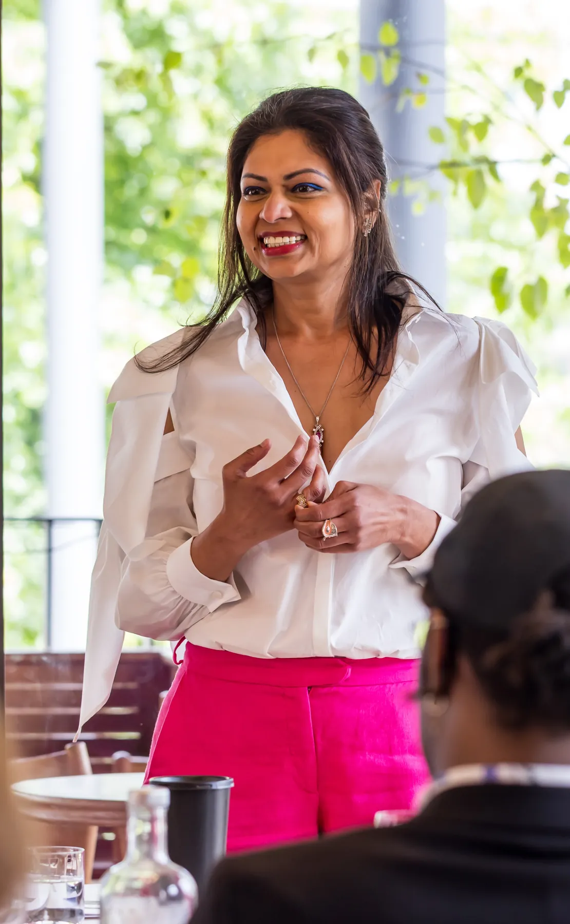 Ruchira Neotia hosting a drinks tasting, smiling at her guests