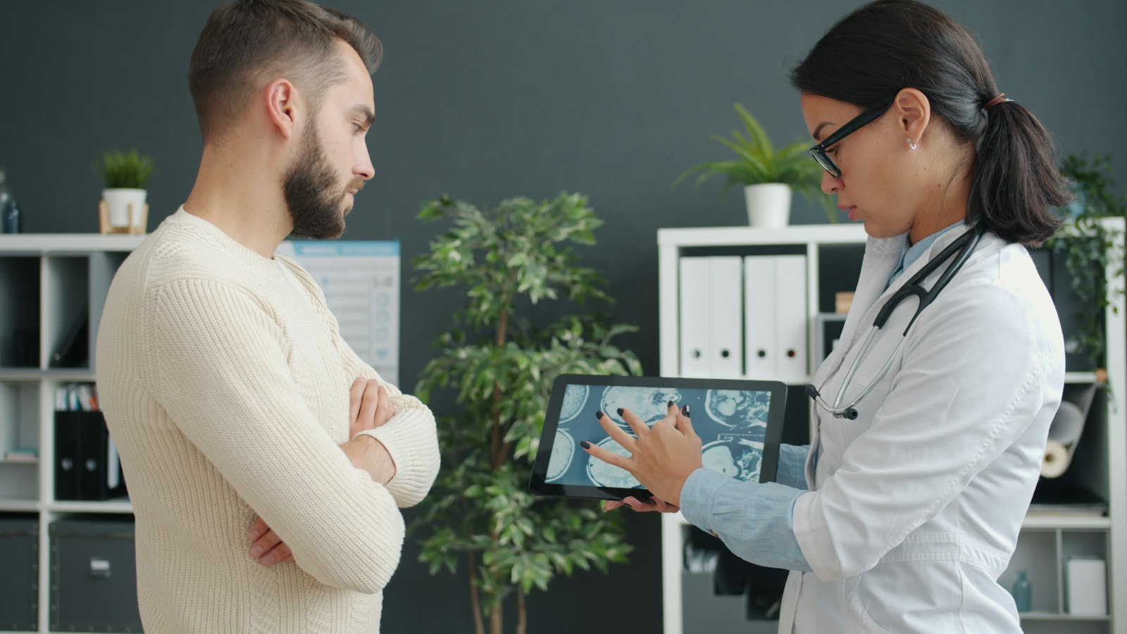 Doctor showing a patient results on a tablet
