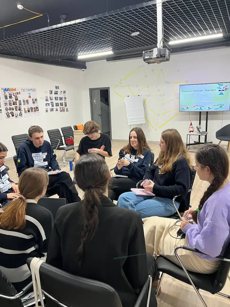 Group of participants sitting in a circle during a reflection session