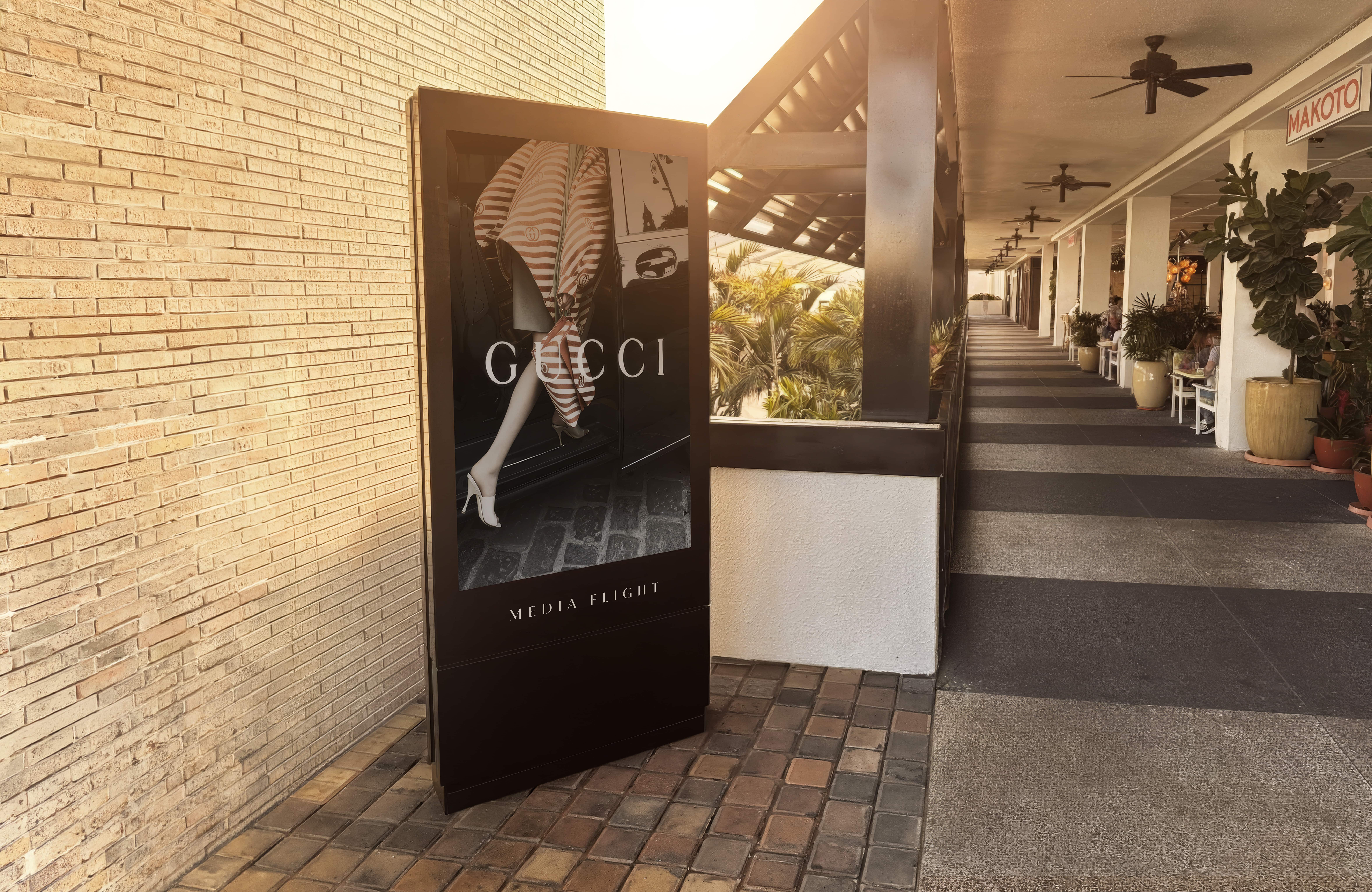 Luxury brand signage in an outdoor retail corridor