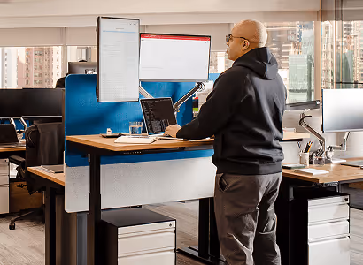 A man working at a standing desk