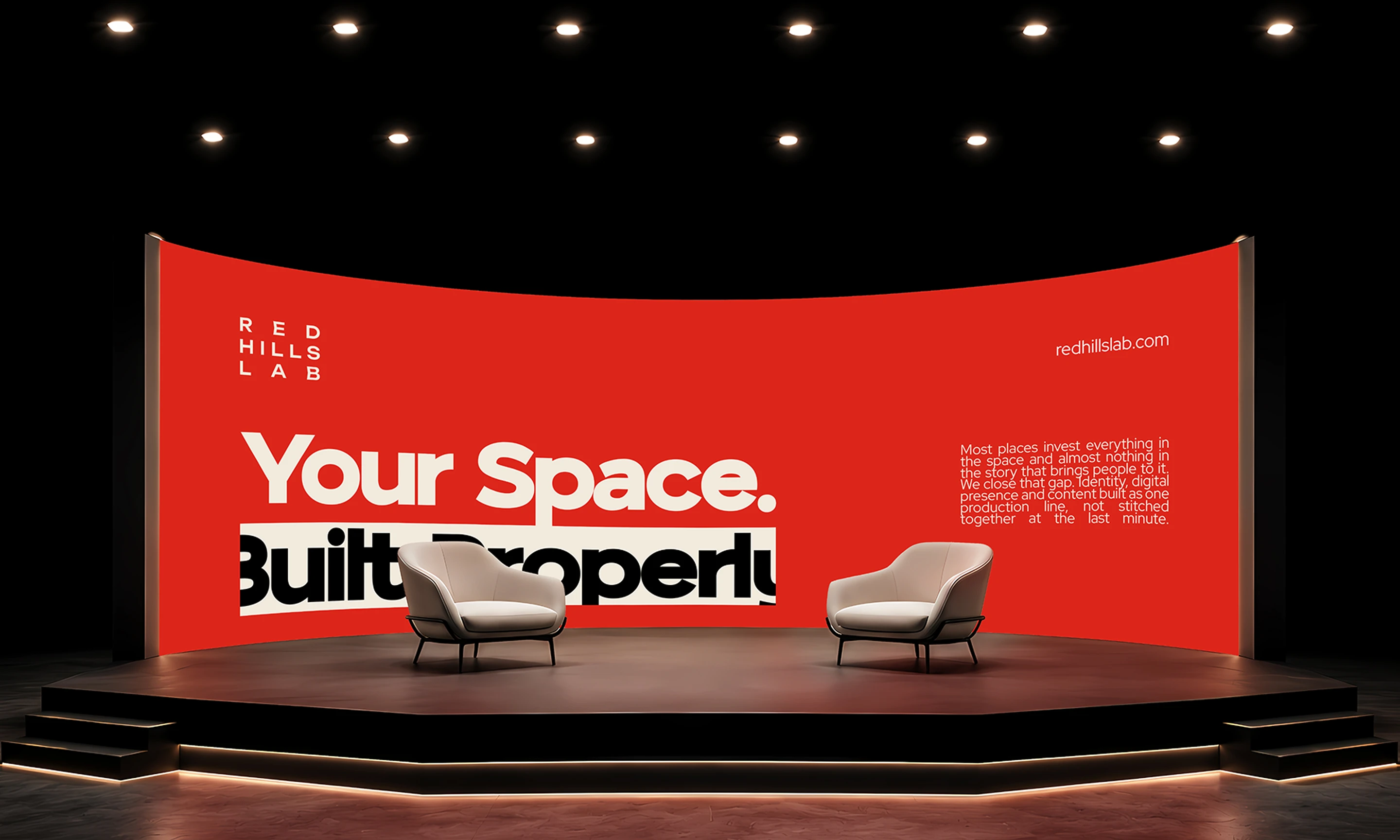 Red Hills Lab stage concept with a red backdrop reading ‘Your Space. Built Properly.’