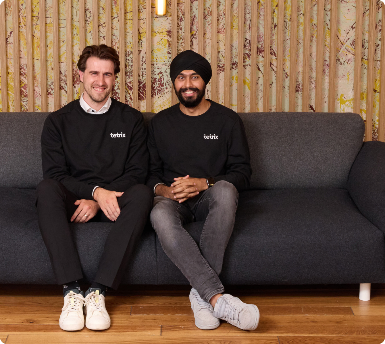 Tetrix founders sitting on a sofa in Tetrix sweatshirts