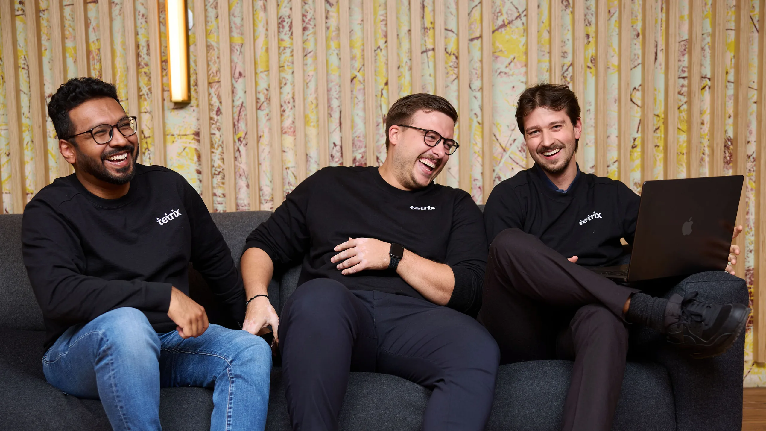 Three Tetrix team members laughing together