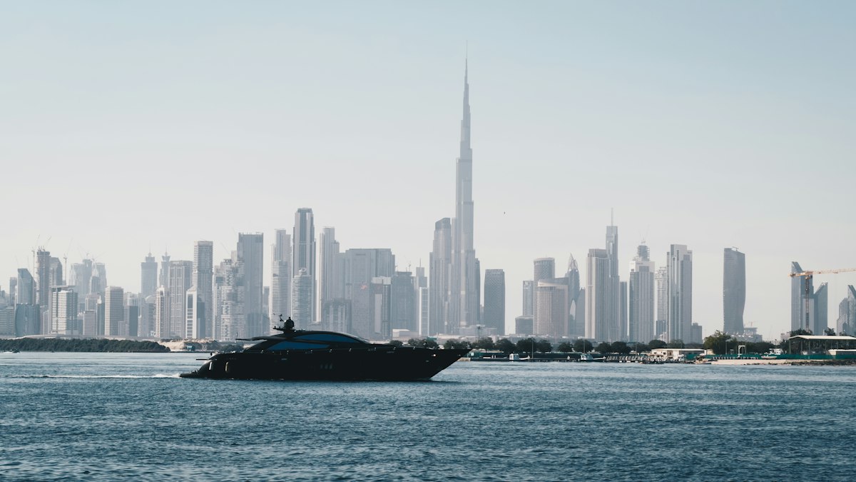 A yacht cruising past the Dubai skyline