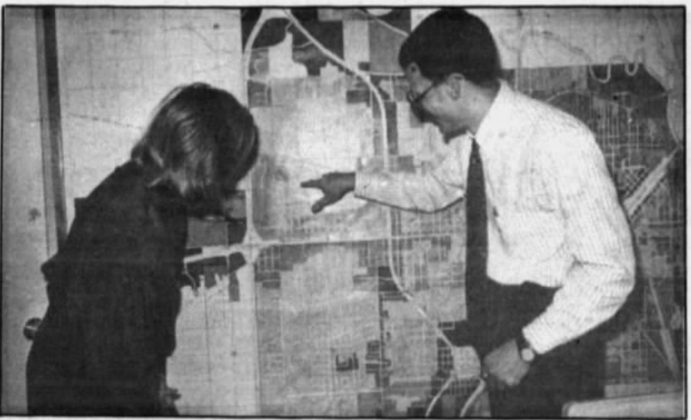 Carlene Hutchinson and Andy Stetelman examine a land use map, Hattiesburg American, March 1, 1992.