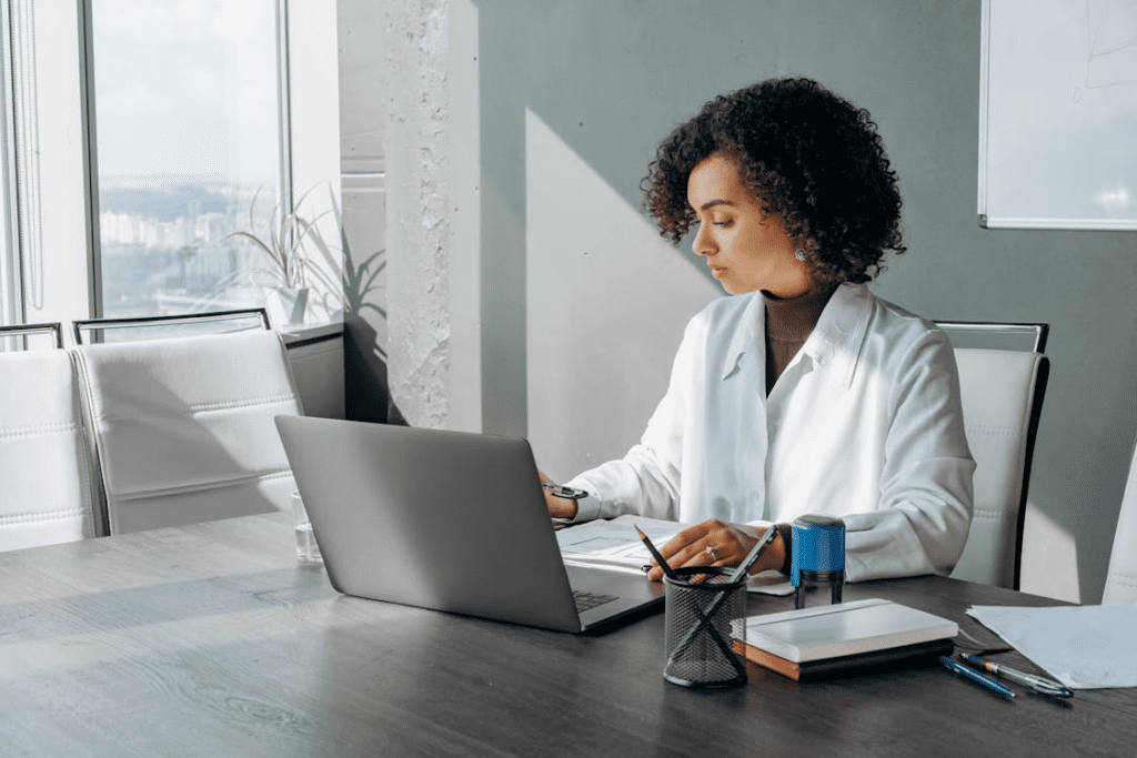 a woman working in the office with a laptop