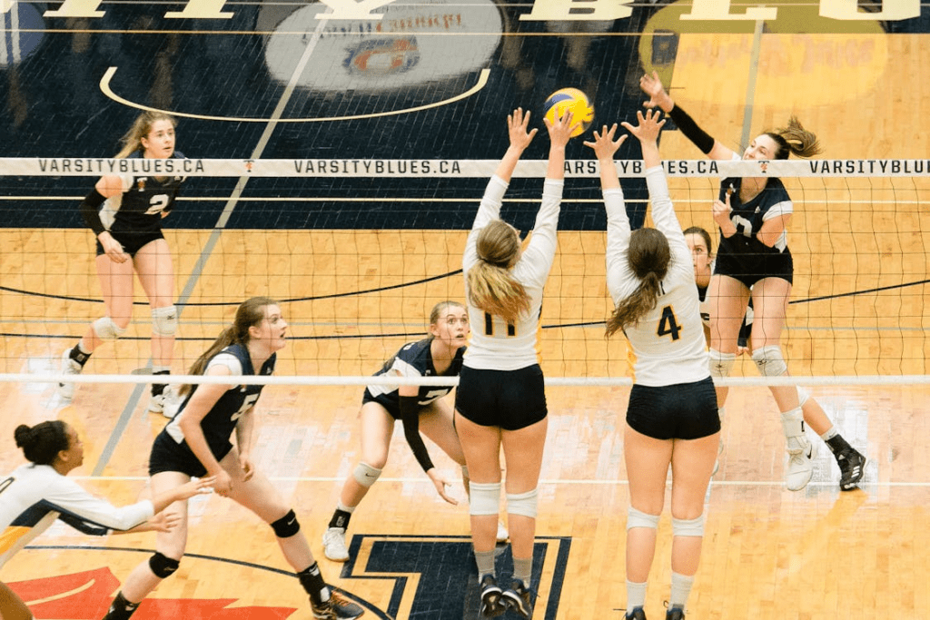 university women athletes playing volleyball