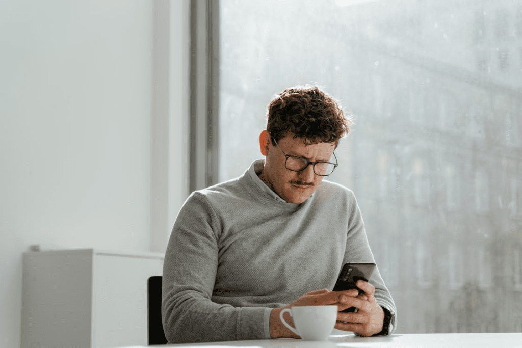 employee checking pay smartphone office