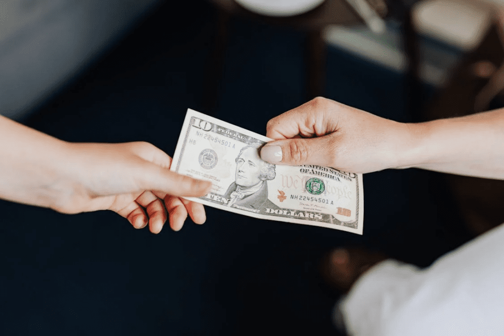 two people exchanging money with each other