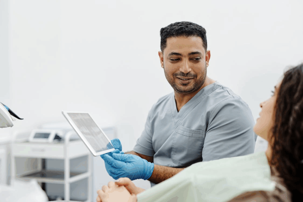 man in gray shirt holding a tablet computer