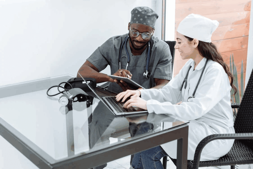 healthcare professionals working on their gadgets while sitting next to each other
