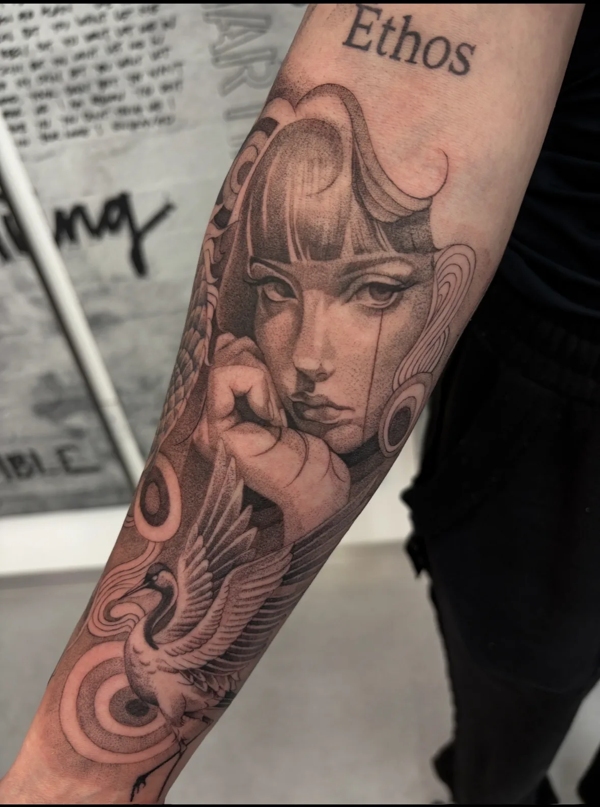 Black and grey portrait tattoo on the forearm by Livi Muir at SANS PATRIE/ STUDIO