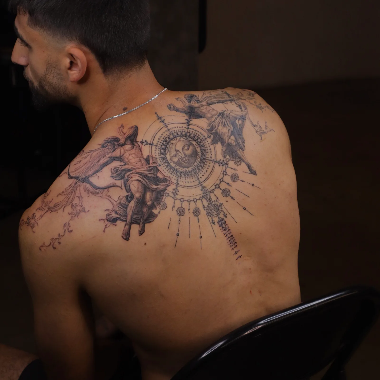 Conceptual back piece with a compass motif by Alfie Watson at SANS PATRIE/ STUDIO