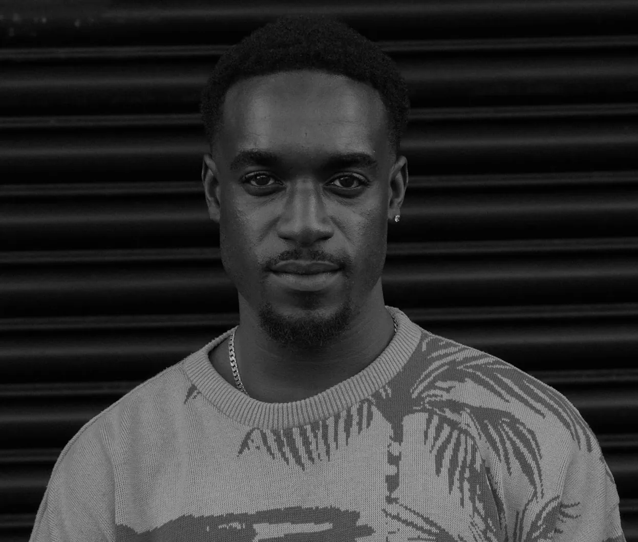 Portrait of Tyrese Gilzene, tattoo artist at SANS PATRIE/ STUDIO