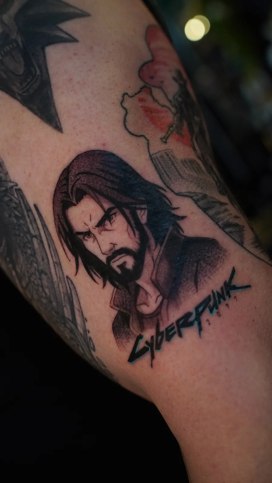 Video game character portrait tattoo with lettering by Draco at SANS PATRIE/ STUDIO