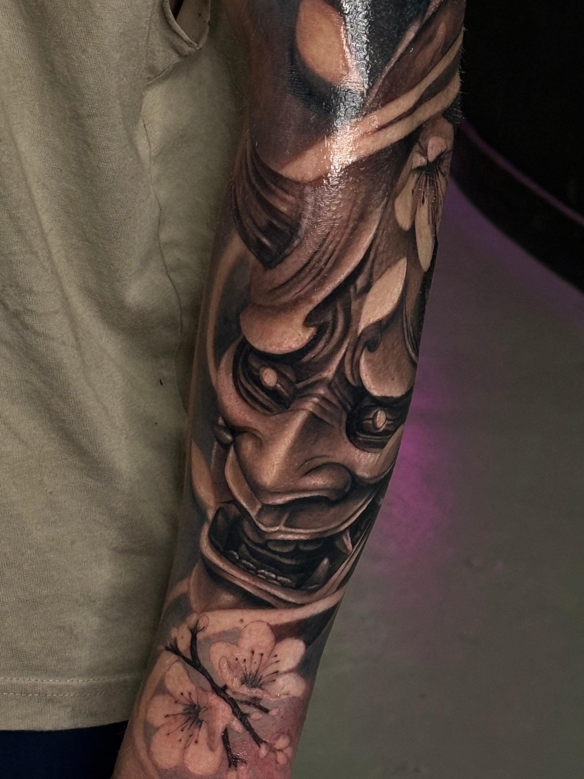 Black and grey hannya mask and cherry blossom sleeve tattoo by Kayley Laroche at SANS PATRIE/ STUDIO