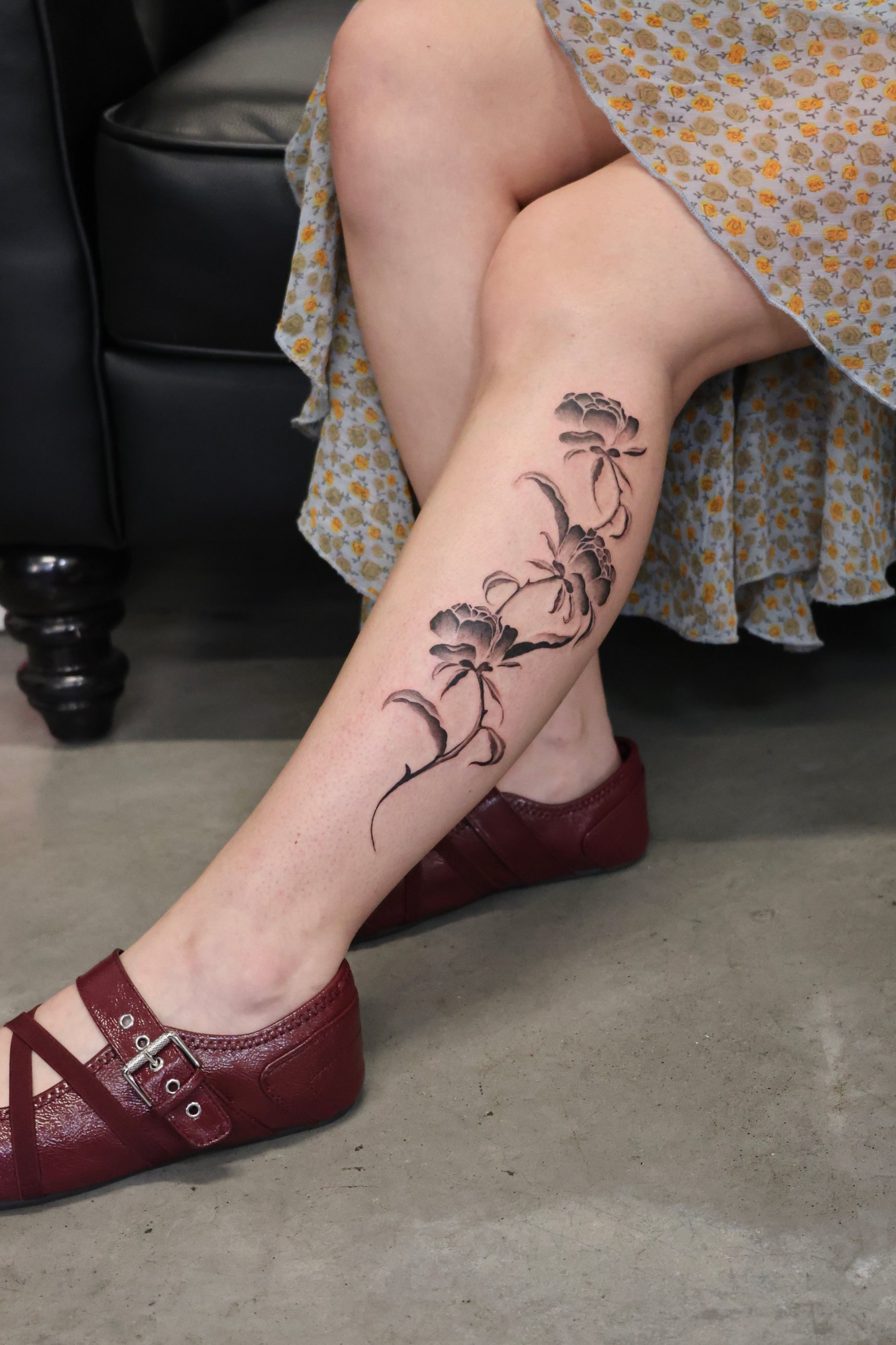 Black and grey peony vine calf tattoo by Kimberley Verana at SANS PATRIE/ STUDIO