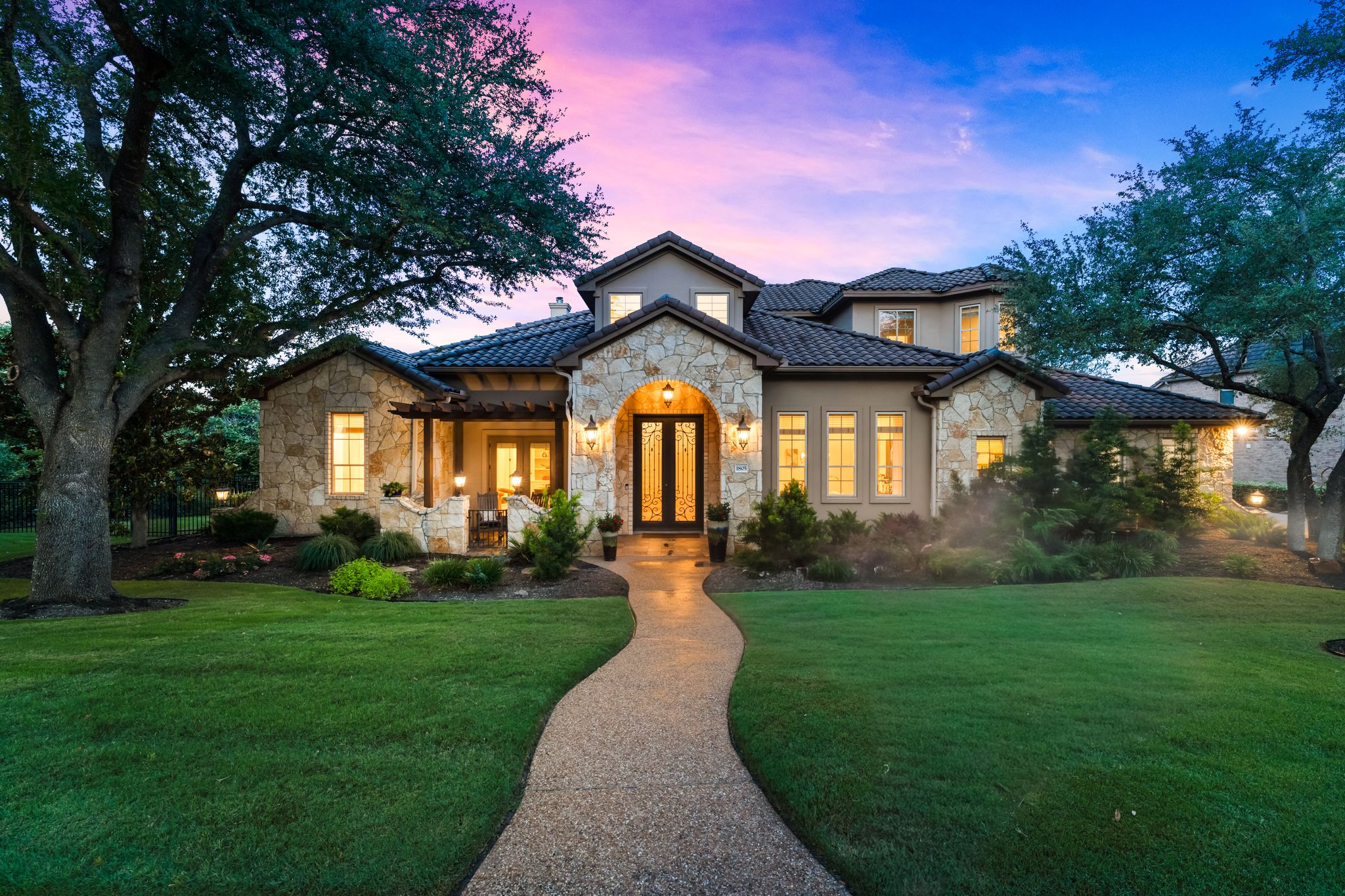 Front of a newly built home on a tree-lined street