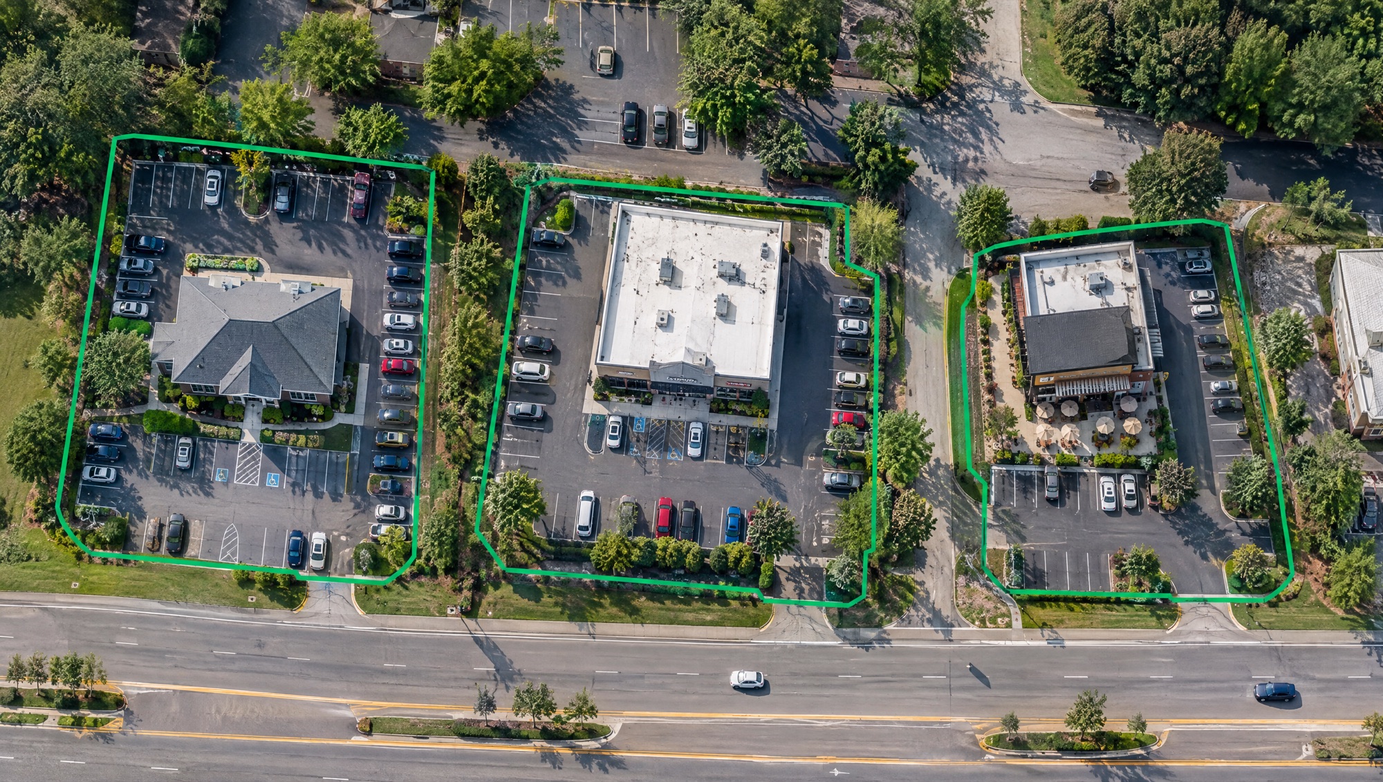 Aerial view of three small business buildings, each outlined by a green geofence