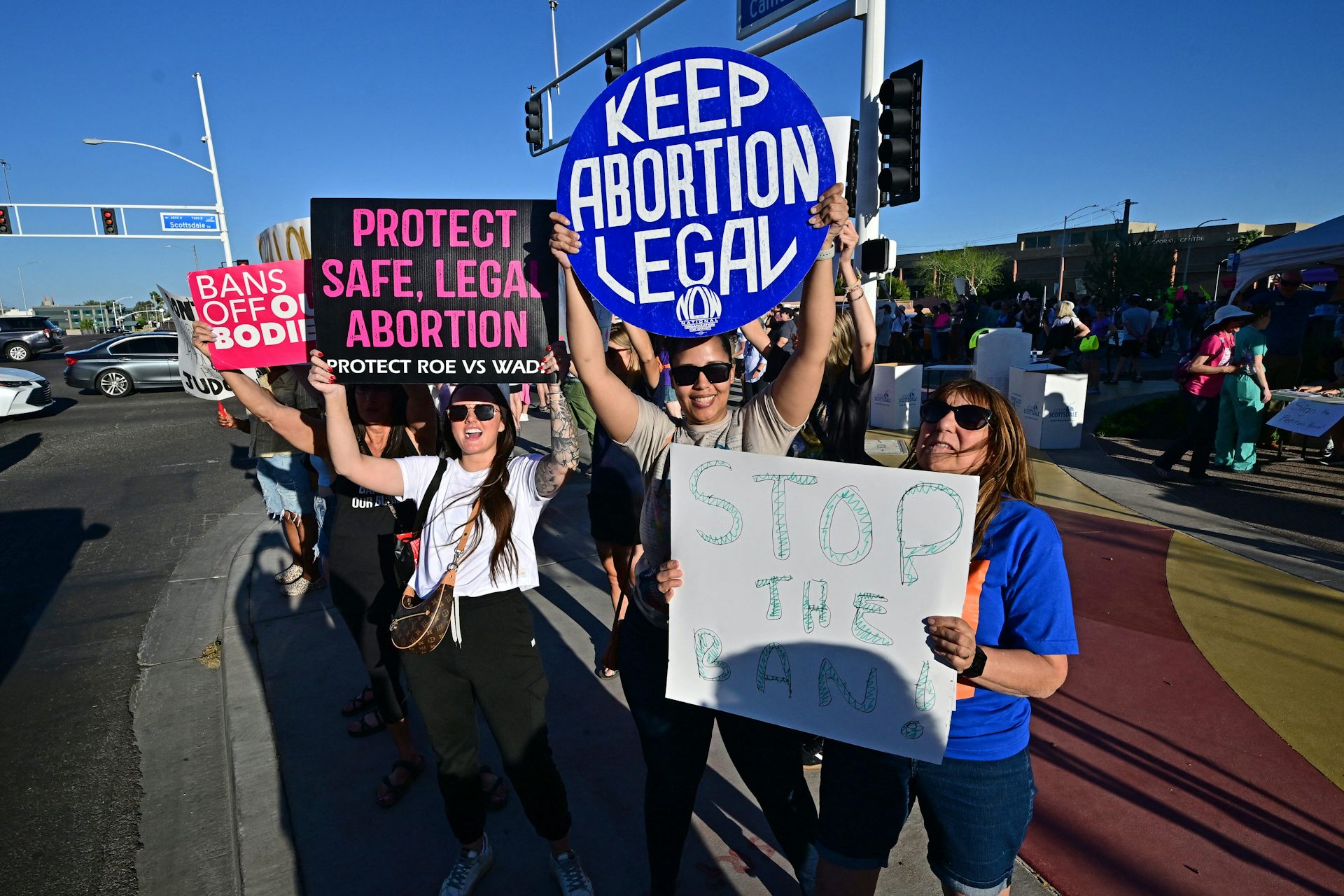 Abortion-rights supporters line up at a busy intersection in Scottsdale, Arizona