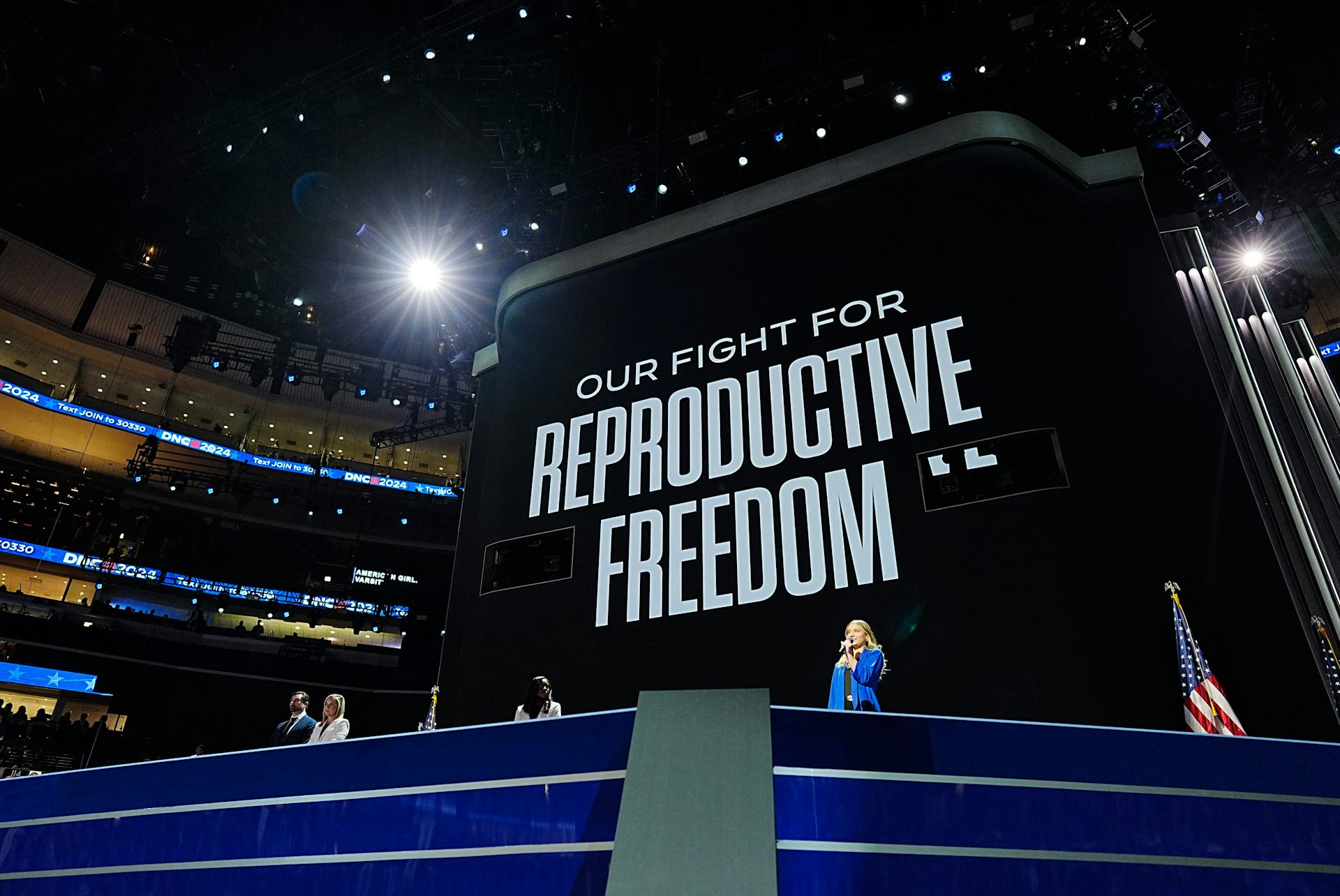 A large black sign with white writing says 'Our fight for reproductive freedom.'