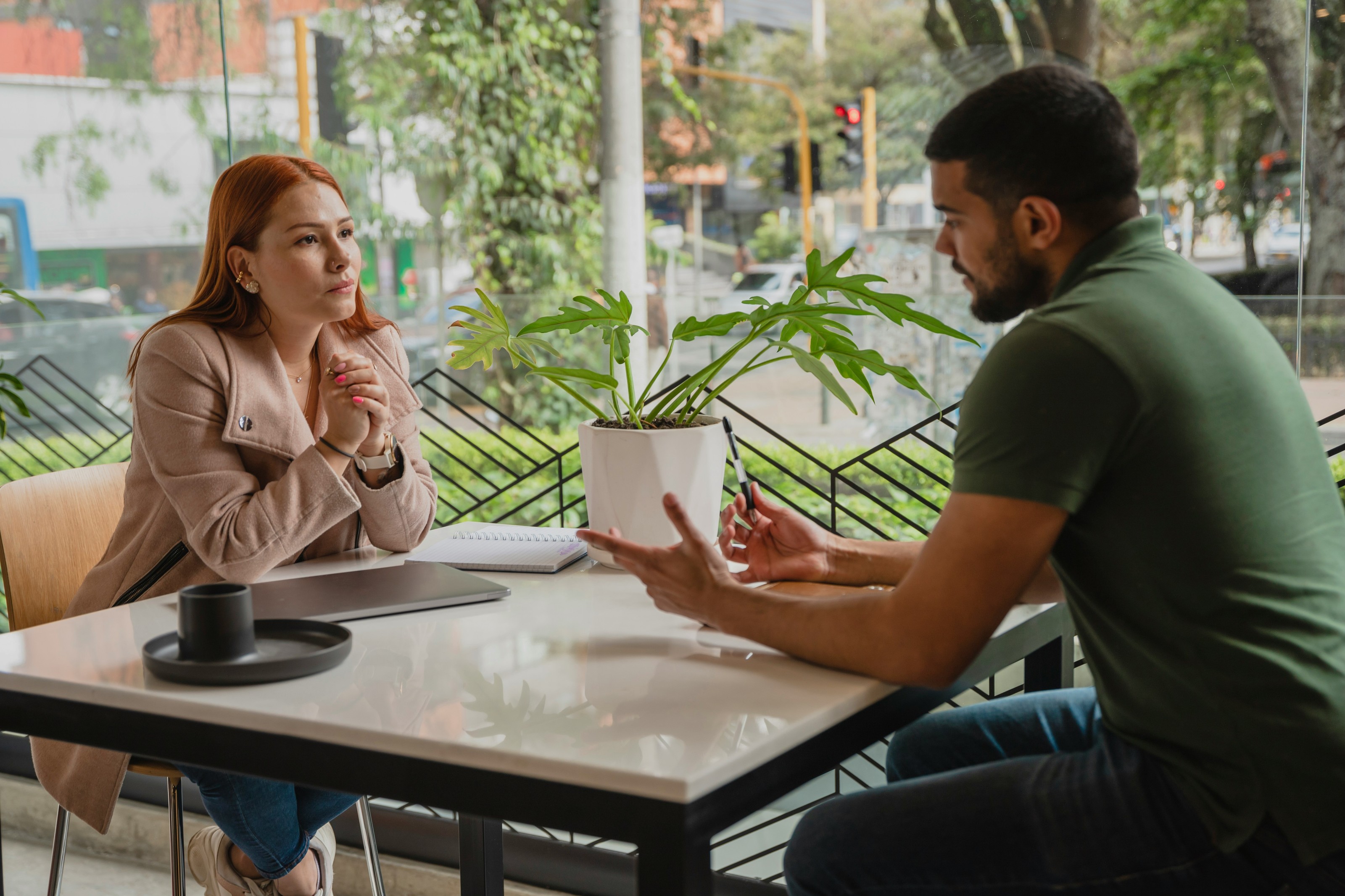 A home buyer talking through mortgage options with a loan officer at a table