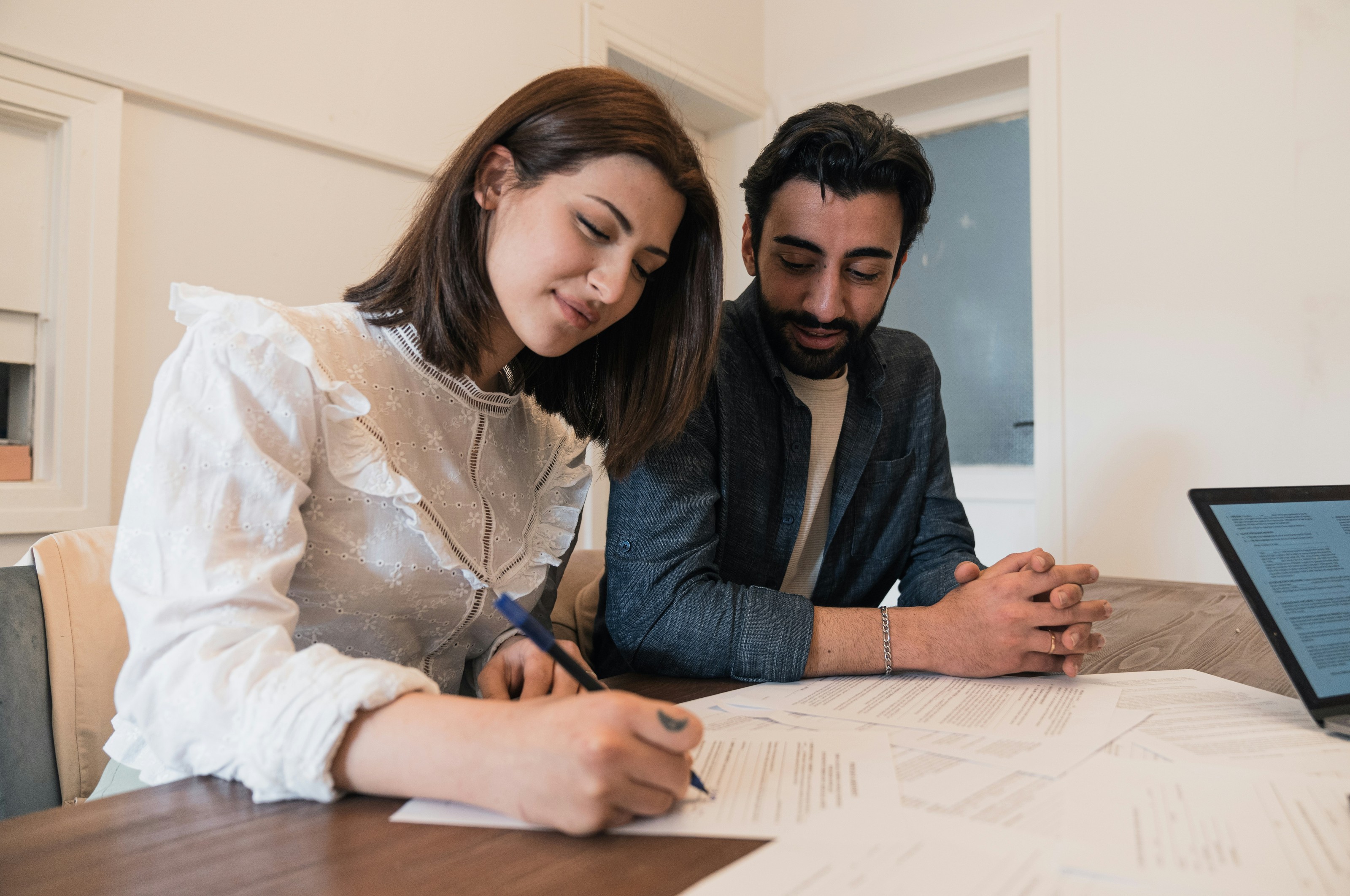 A couple reviewing paperwork together at a table