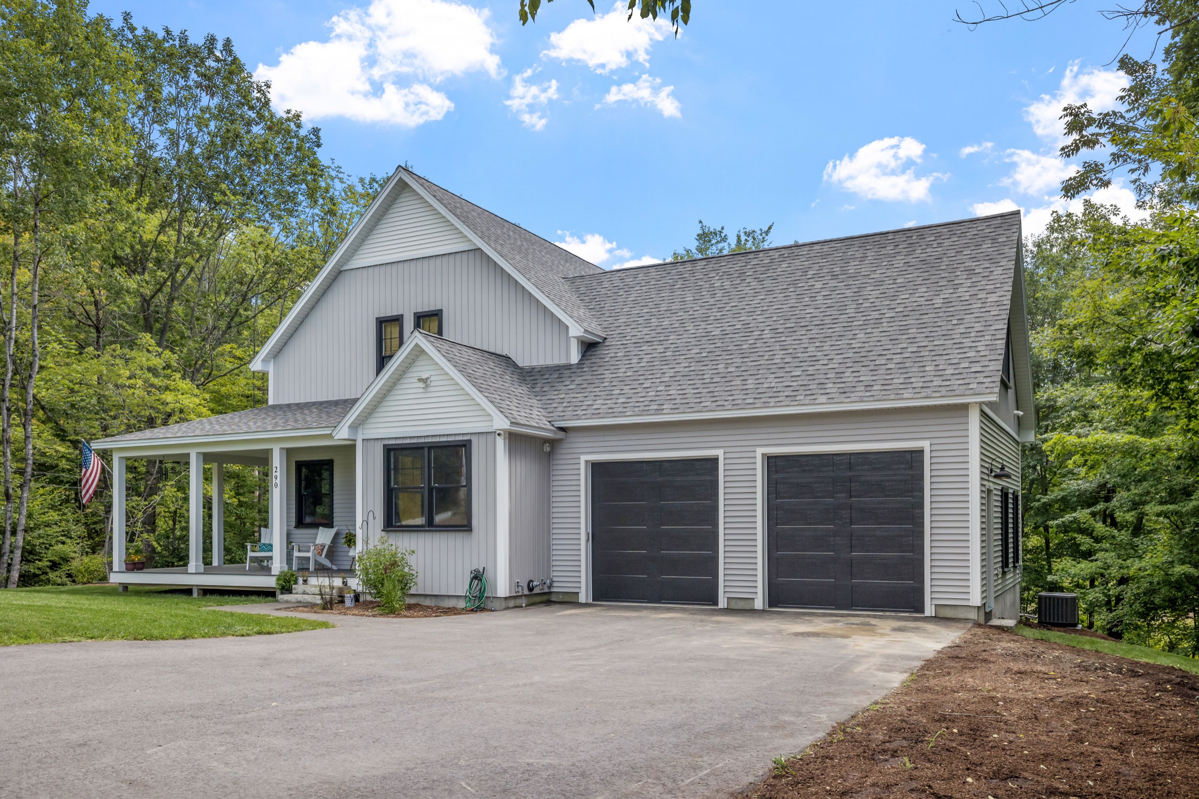 A gray two-story house with a two-car garage