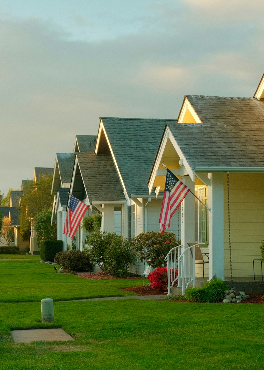 A row of houses with American flags on their porches