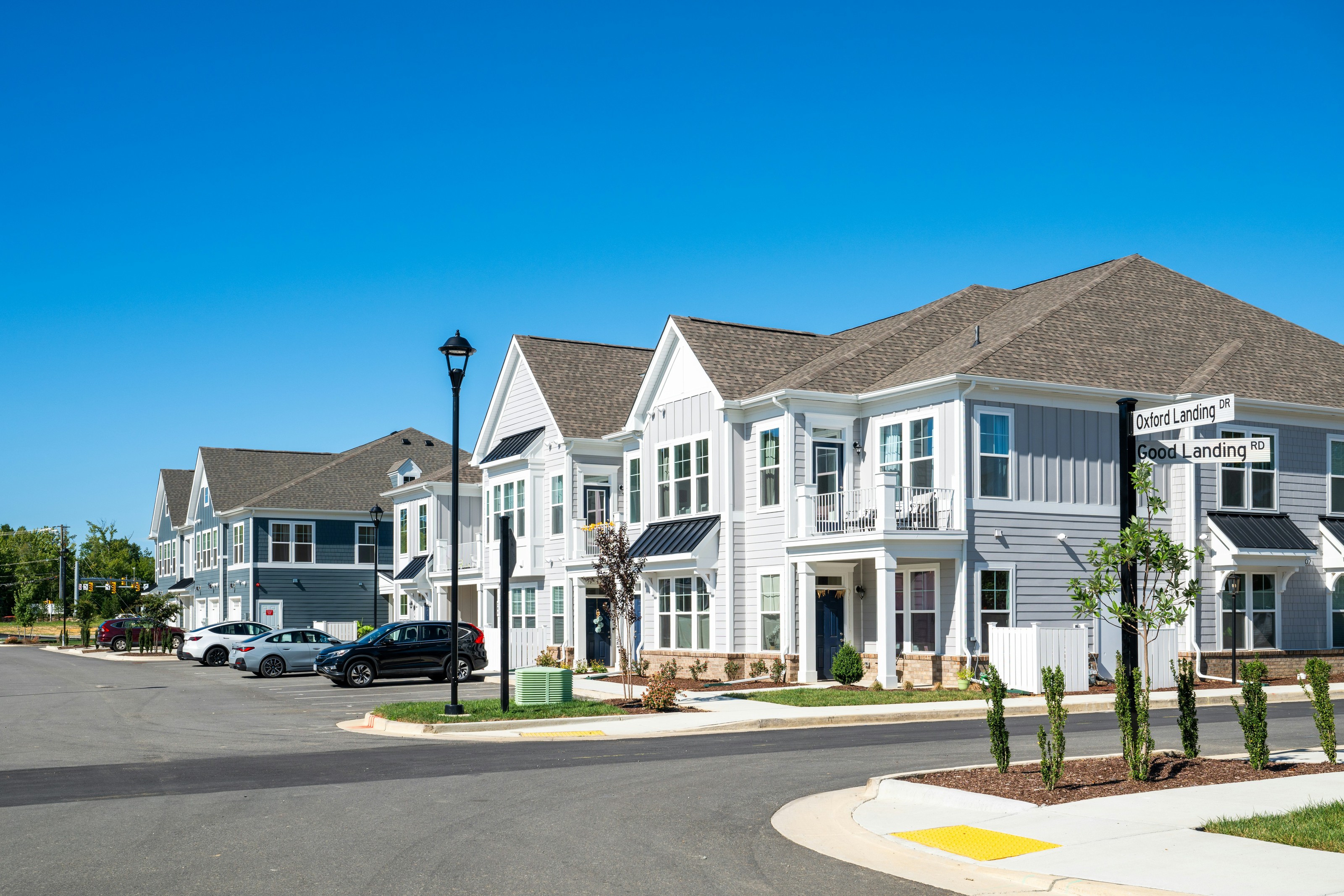 A row of new homes along a sunny neighborhood street
